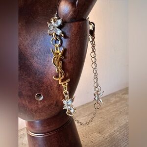 Gold tone bracelet with Butterflies and YSL charm logo